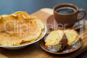 Round cake slice with pancake and coffee. Traditional cuisine.