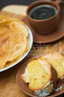 Round cake slice with pancake and coffee. Traditional cuisine.
