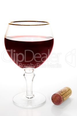 Glass of red wine and cork