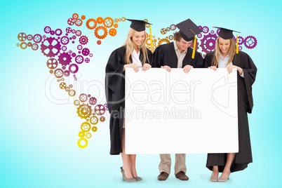 Composite image of three smiling students in graduate robe holdi