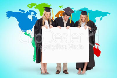 Composite image of three smiling students in graduate robe holdi