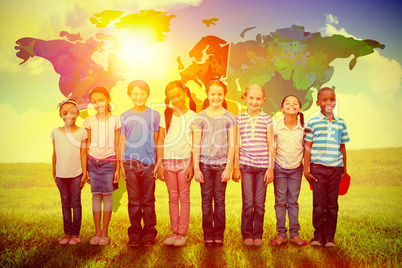 Composite image of cute pupils smiling at camera in classroom