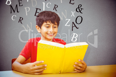 Composite image of cute boy reading book in library