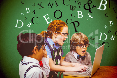 Composite image of pupils using laptop