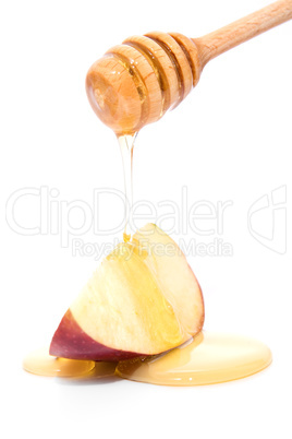 Stick with honey dripping on red apple isolated on white