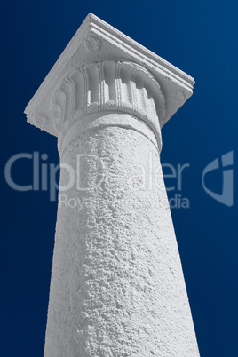 White column and capital against the dark blue sky