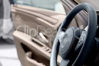 Car interior , steering wheel and open door.