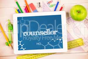 Counsellor against students desk with tablet pc
