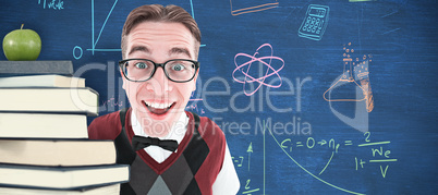 Composite image of smiling geeky hipster looking at camera