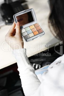 Girl using Eyeliner. Picture with short DOF area.