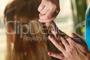 Hairdresser making female haircut