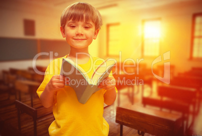 Composite image of happy pupil with book