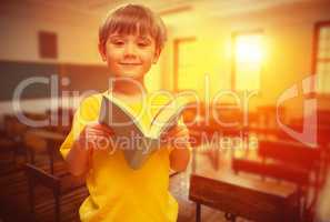 Composite image of happy pupil with book