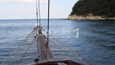 Boat sailing in the sea with coast at left side