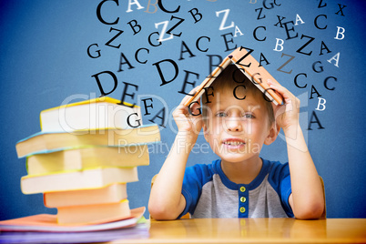 Composite image of cute boy with book on head