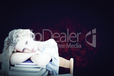 Composite image of tired teeenager sleeping in a library