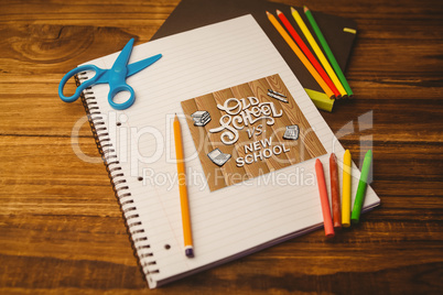 Composite image of notepad on student desk