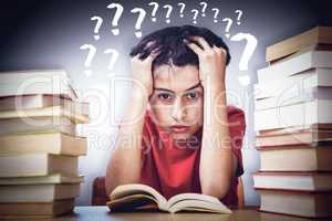 Composite image of tensed boy sitting with stack of books