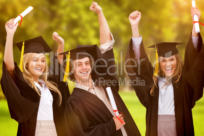 Composite image of three students in graduate robe raising their