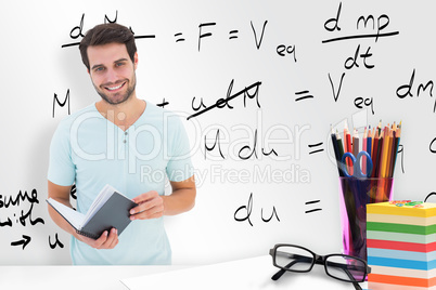 Composite image of student holding book