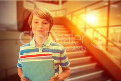 Composite image of cute pupil smiling at camera in library