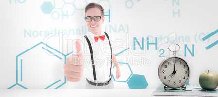 Composite image of geeky young hipster showing thumbs up