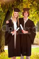 Composite image of two students in graduate robe shoulder to sho