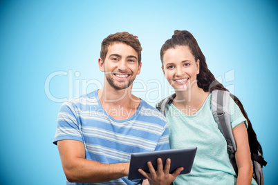 Composite image of students using tablet and smiling