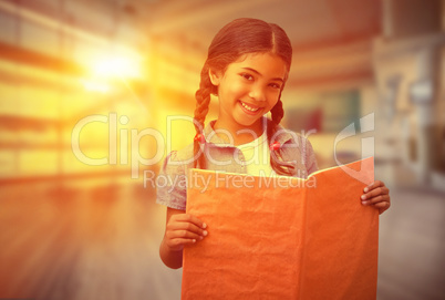 Composite image of cute pupil smiling at camera during class pre