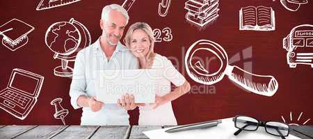 Composite image of mature students using laptop