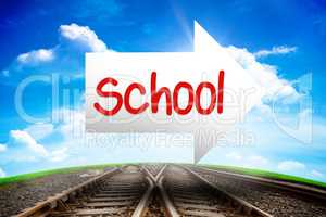 School against railway leading to blue sky