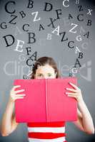 Composite image of student holding book over face