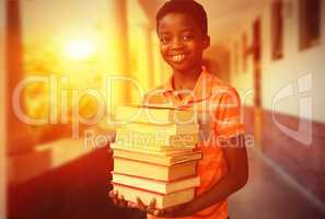 Composite image of portrait of cute boy carrying books in librar