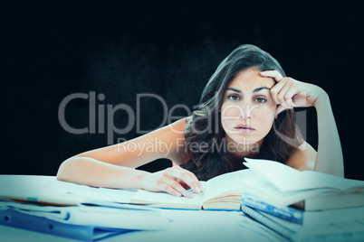 Composite image of bored student doing her homework