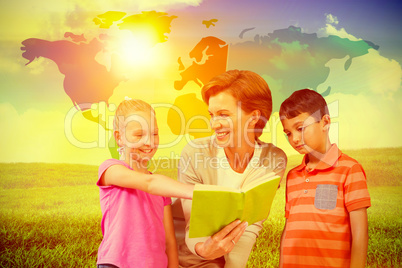 Composite image of teacher reading book with pupils at library