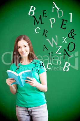 Composite image of student picking a book from shelf in library