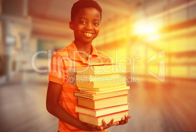 Composite image of portrait of cute boy carrying books in librar