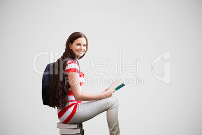 Composite image of student reading book in library