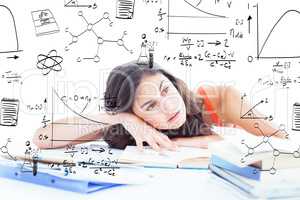 Composite image of bored female student doing her homework