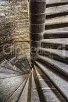 Vintage old spiral stone staircase in the style of grunge