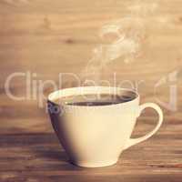 Steaming hot coffee in white cup