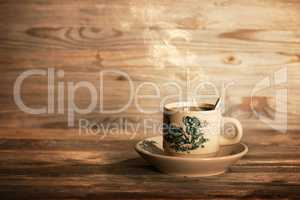 Steaming traditional Chinese coffee in vintage mug and saucer