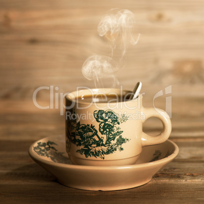 Steaming traditional oriental Chinese coffee in vintage mug and