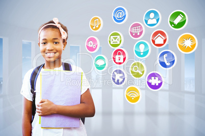 Composite image of little girl holding folders in school corrido