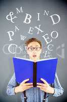 Composite image of geeky businessman holding a book