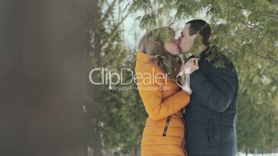 Romantic couple kissing in forest