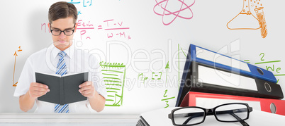 Composite image of geeky businessman reading from book