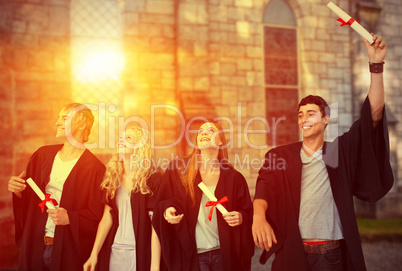 Composite image of group of people celebrating after graduation