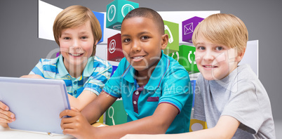 Composite image of cute pupils using tablet computer in library