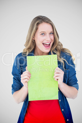 Composite image of smiling student holding notebook